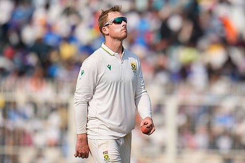 South Africa's Simon Harmer prepares to bowl his next delivery on the third day of the first cricket test match between India and South Africa in Kolkata, India