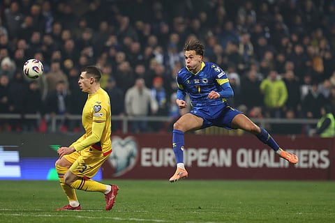 Bosnia's Amar Dedic, right, and Romania's Bogdan Racovitan challenge for the ball during the 2026 World Cup Group H qualifier soccer match between Bosnia and Romania in Zenica, Bosnia and Herzegovina.