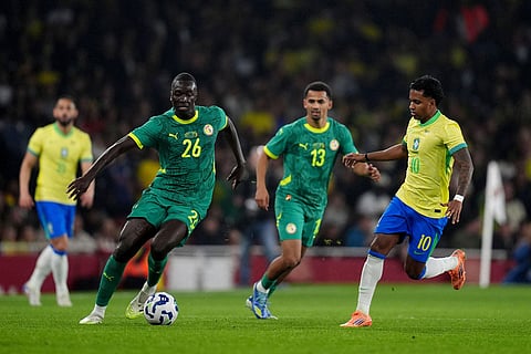 Senegal's Pape Gueye, left, and Brazil's Rodrygo battle for the ball during an international soccer match between Brazil and Senegal at the Emirates Stadium, London.