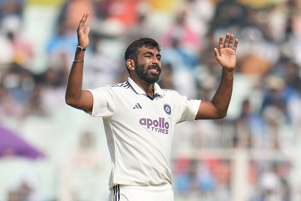 Indias Jasprit Bumrah reacts after bowling a delivery