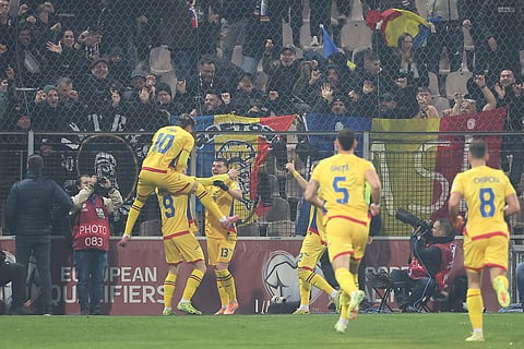 Romania's Daniel Birligea, second from left, celebrates with teammates after scoring the opening goal during the 2026 World Cup Group H qualifier soccer match between Bosnia and Romania in Zenica, Bosnia and Herzegovina.