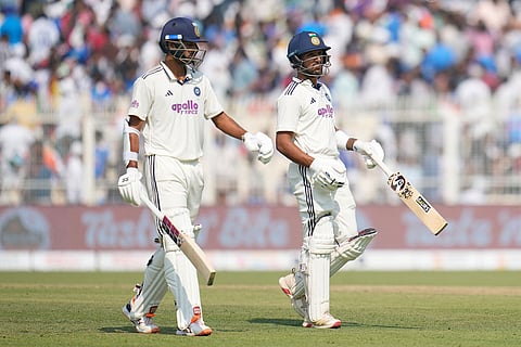 India's Dhruv Jurel, right, and batting partner Washington Sundar leave the field for lunch on the third day of the first cricket test match between India and South Africa in Kolkata, India.