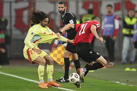 Spain's Marc Cucurella, left, fights for the ball with Georgia's Giorgi Kvernadze during a World Cup 2026 group E qualifying soccer match between Georgia and Spain in Tbilisi, Georgia.