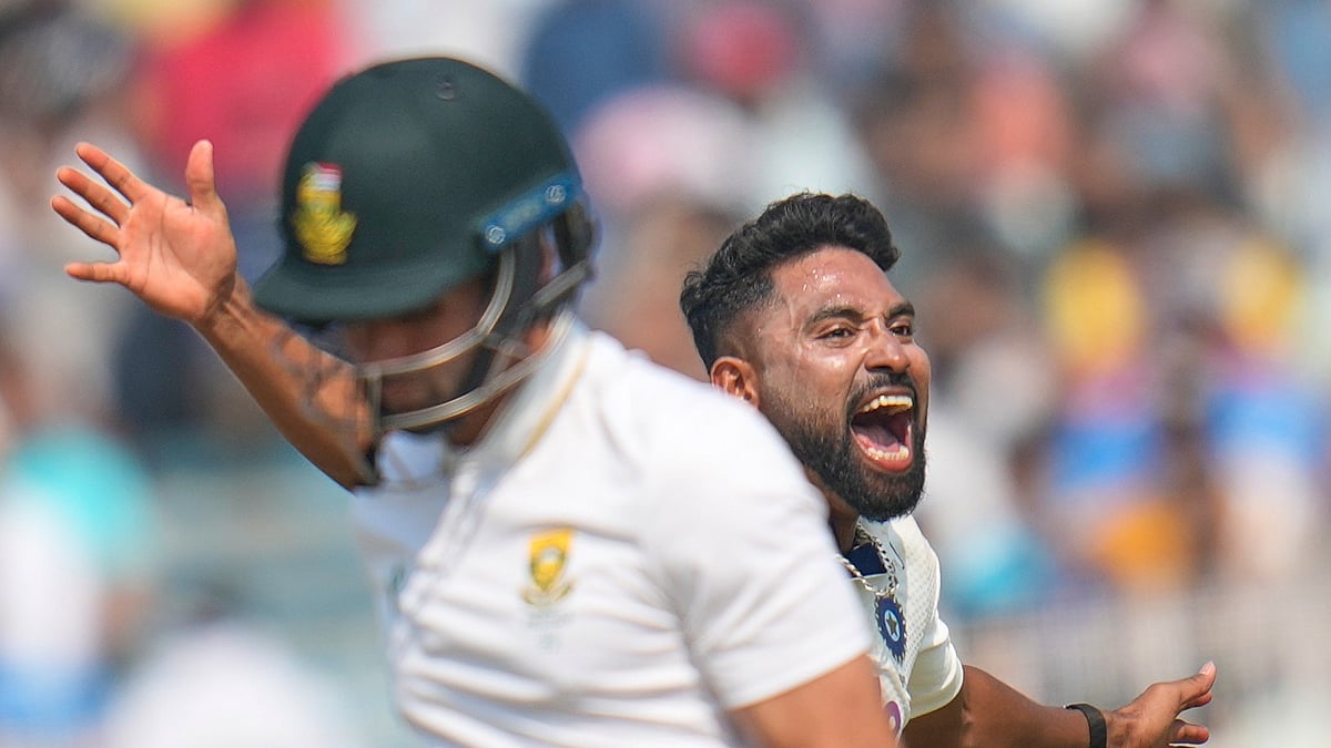 India's Mohammed Siraj celebrates the dismissal of South Africa's Keshav Maharaj, front, on the third day of the first cricket test match between India and South Africa in Kolkata, India, Sunday, Nov. 16, 2025. - (AP Photo/Aijaz Rahi)