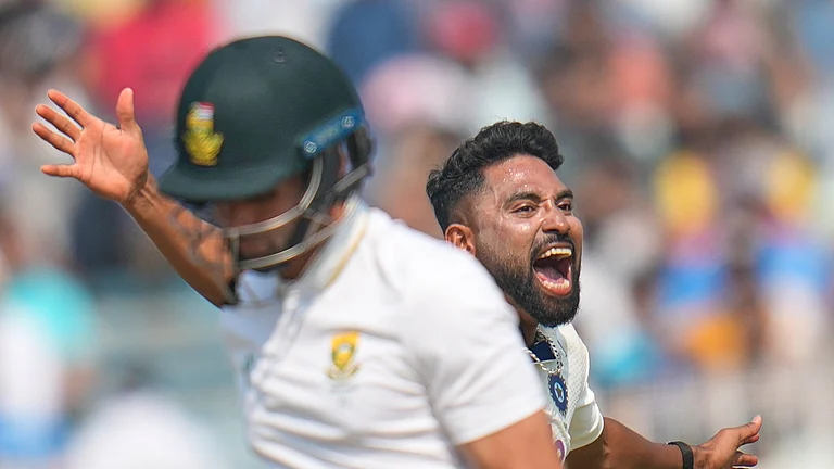 India's Mohammed Siraj celebrates the dismissal of South Africa's Keshav Maharaj, front, on the third day of the first cricket test match between India and South Africa in Kolkata, India, Sunday, Nov. 16, 2025. - (AP Photo/Aijaz Rahi)