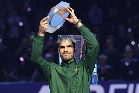 Spain's Carlos Alcaraz holds runners-up trophy after losing the final tennis match of the ATP World Tour Finals against Italy's Jannik Sinner, in Turin, Italy.