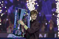 ATP Finals 2025: Jannik Sinner Sees Off Carlos Alcaraz Threat To Defend Title In Turin | Photo: AP/Antonio Calanni : Italy's Jannik Sinner holds the trophy after winning the final tennis match of the ATP World Tour Finals against Spain's Carlos Alcaraz in Turin, Italy.