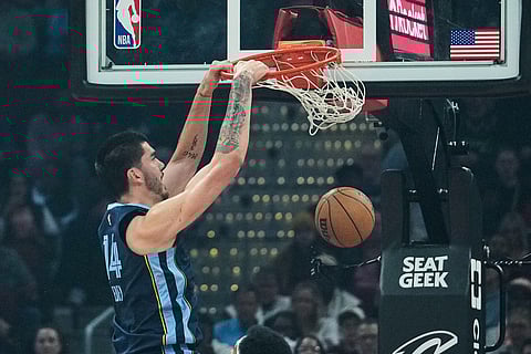 Memphis Grizzlies center Zach Edey dunks in the first half of an NBA basketball game against the Cleveland Cavaliers in Cleveland. 