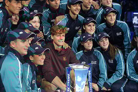 Italy's Jannik Sinner poses with the trophy after winning the final tennis match of the ATP World Tour Finals against Spain's Carlos Alcaraz in Turin, Italy.