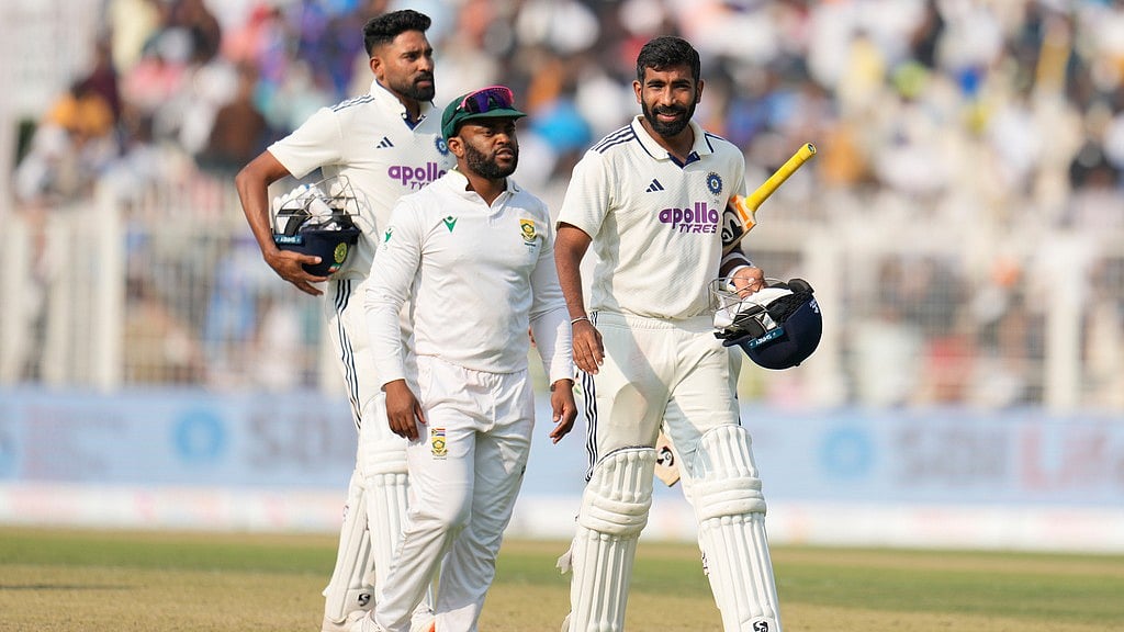 India's Jasprit Bumrah, right, and batting partner Mohammed Siraj, left, leave the field with South Africa's captain Temba Bavuma at the end of the first Test in Kolkata. - AP