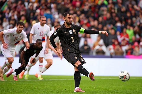 Portugal's Bruno Fernandes scores his side's seventh goal from the penalty spot during a World Cup 2026 group F qualifying soccer match between Portugal and Armenia in Porto, Portugal.