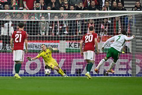 Ireland's Troy Parrott, right, scores his side's opening goal during the World Cup 2026 group F qualifying soccer match between Hungary and Ireland in Budapest, Hungary.