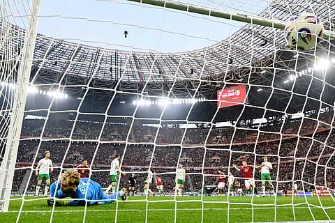 Ireland goalkeeper Caoimhin Kelleher fails to save a shot by Hungary's Barnabas Varga who scored his side's second goal during the World Cup 2026 group F qualifying soccer match between Hungary and Ireland in Budapest, Hungary.