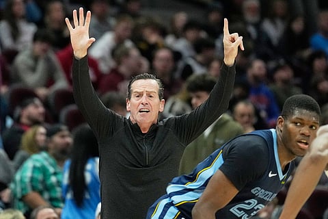 Cleveland Cavaliers head coach Kenny Atkinson gestures behind Memphis Grizzlies forward Cedric Coward (23) in the second half of an NBA basketball game in Cleveland. 