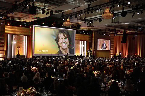 Tom Cruise, left, receives an Academy honorary award as Alejandro González Iñárritu looks on during the 16th Governors Awards at The Ray Dolby Ballroom in Los Angeles. 