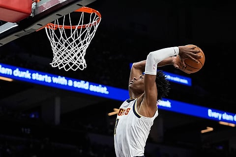 Denver Nuggets guard Peyton Watson (8) goes up for a dunk during the second half of an NBA basketball game against the Minnesota Timberwolves in Minneapolis. 