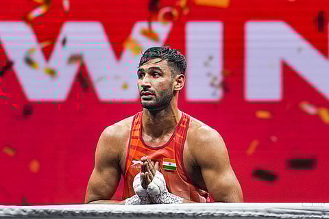 India's Naveen Kumar celebrates after winning the men's 90kg quarter-final match against Kazakhstan's Bekzat Tangatar at the World Boxing Cup Finals 2025, in Greater Noida, Uttar Pradesh.