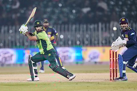 Pakistan's Hussain Talat, left, plays a shot as Sri Lanka's Kusal Mendis, right, watches during the third one day international cricket match between Pakistan and Sri Lanka, in Rawalpindi, Pakistan.