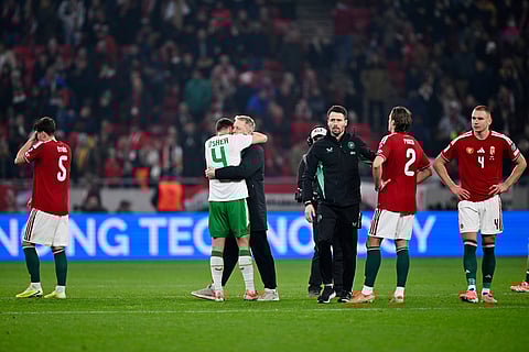 Ireland coach Heimir Hallgrimsson hugs Ireland's Dara O'Shea at the end of the World Cup 2026 group F qualifying soccer match between Hungary and Ireland in Budapest, Hungary.