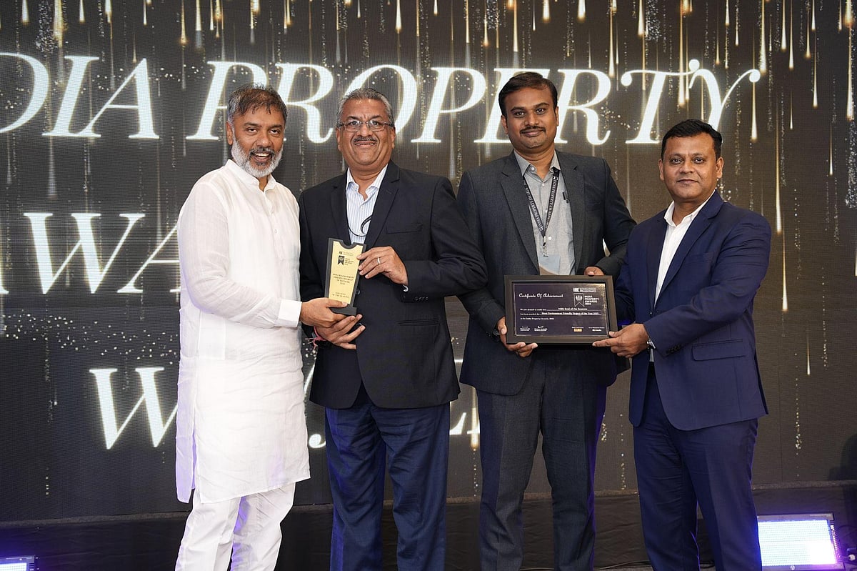 Four men accept an "India Property Award" on stage