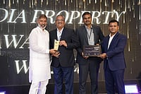 Four men accept an "India Property Award" on stage