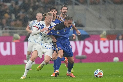 Norway's Erling Haaland, centre left, and Italy's Davide Frattesi, right, challenge for the ball during the 2026 World Cup Group I qualifier soccer match between Italy and Norway in Milan, Italy.