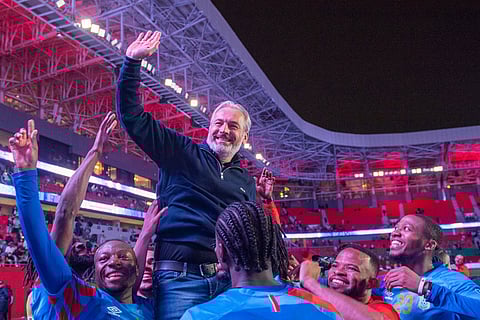 Congo national team members celebrate with their coach Sebastien Desabre after being qualified for the FIFA 2026 soccer World Cup in the African qualifier final match against Nigeria, in Rabat, Morocco.