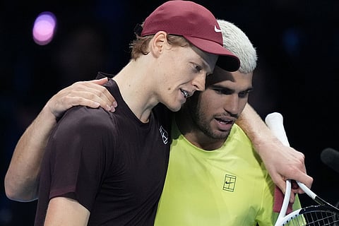 Italy's Jannik Sinner, left, and Spain's Carlos Alcaraz hug after the final tennis match of the ATP World Tour Finals, in Turin, Italy.