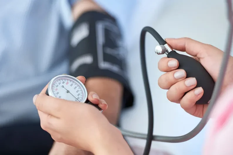 A medical professional checking blood pressure of a patient