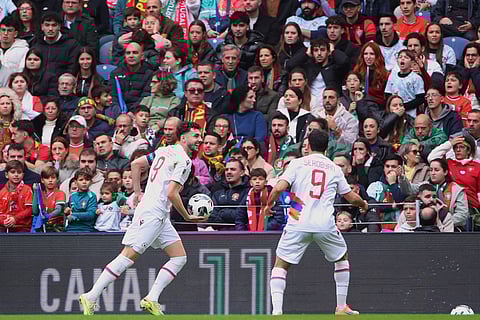 Armenia's Eduard Spertsyan, left, celebrates after scoring his side's first goal during a World Cup 2026 group F qualifying soccer match between Portugal and Armenia in Porto, Portugal.