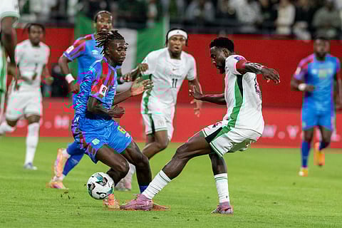 Congo's Ngal'ayel Mukau challenges Nigeria's Wilfred Ndidi during the World Cup African qualifier soccer match between Congo and Nigeria, in Rabat, Morocco.