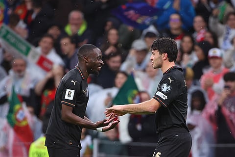 Portugal's Joao Neves, right, celebrates with Carlos Forbs after scoring his side's eigth goal during a World Cup 2026 group F qualifying soccer match between Portugal and Armenia in Porto, Portugal.