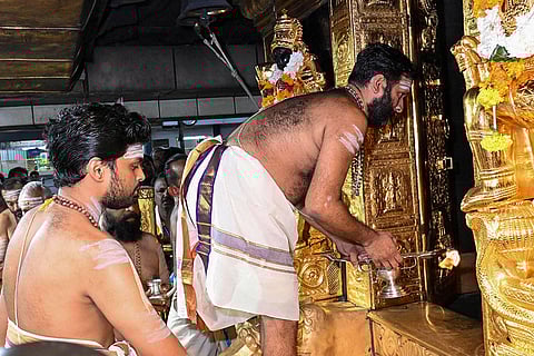 A priest performs rituals as part of the 'Vrischikam' as the Sabarimala temple opened for 'Mandala-Makaravilakku' pilgrimage season, in Pathanamthitta.
