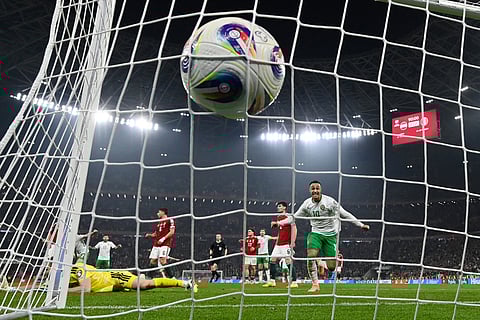 Hungary goalkeeper Denes Dibusz fails to save a shot by Ireland's Troy Parrott who scored his side's third goal during the World Cup 2026 group F qualifying soccer match between Hungary and Ireland in Budapest, Hungary.