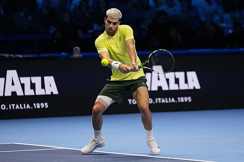 Spain's Carlos Alcaraz returns to Italy's Jannik Sinner during the final tennis match of the ATP World Tour Finals, in Turin, Italy.
