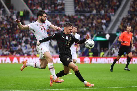 Portugal's Francisco Conceicao vies for the ball with Armenia's Nayair Tiknizyan, left, during a World Cup 2026 group F qualifying soccer match between Portugal and Armenia in Porto, Portugal.