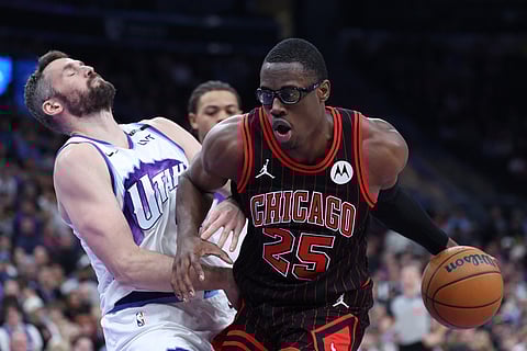 Chicago Bulls forward Jalen Smith (25) drives against Utah Jazz forward Kevin Love, left, during the second half of an NBA basketball game in Salt Lake City. 