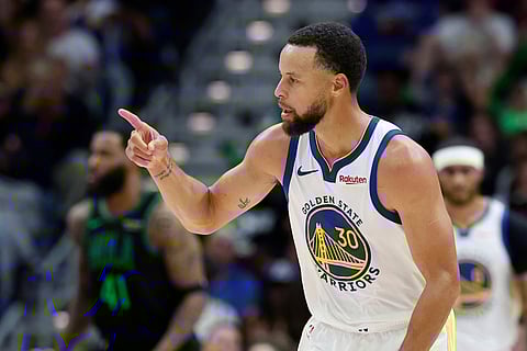Golden State Warriors guard Stephen Curry reacts to a three-point basket against the New Orleans Pelicans during the third quarter of an NBA basketball game in New Orleans. 