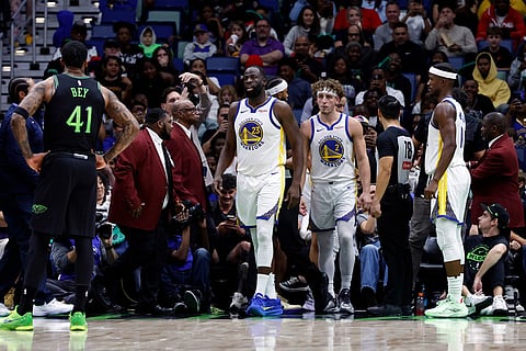Golden State Warriors forward Draymond Green (23) walks back to the court after an altercation with a fan during the second quarter of an NBA basketball game against the New Orleans Pelicans in New Orleans. 