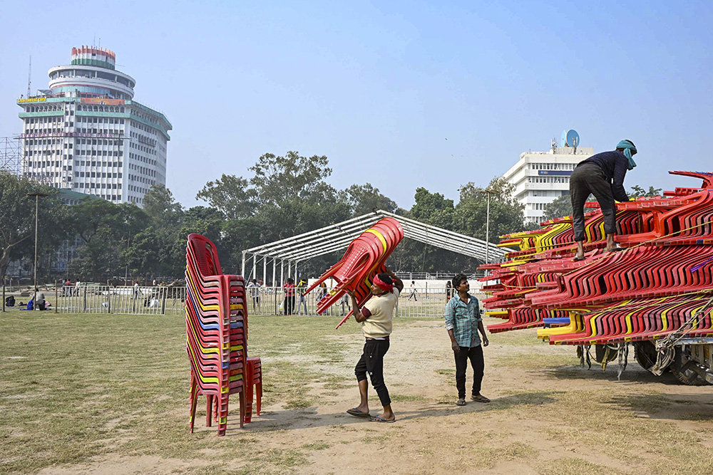 Workers prepare the venue for the swearing-in ceremony of the new government in Bihar, in Patna.
