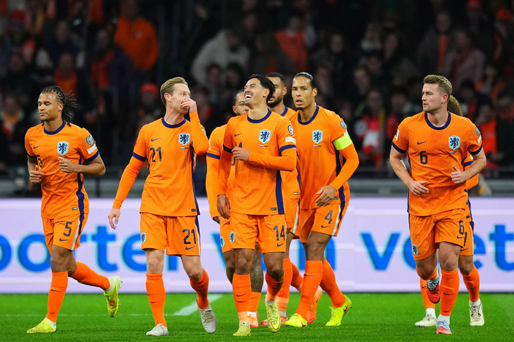 Netherlands' Tijjani Reijnders (14) celebrates scoring his side's opening goal during a World Cup 2026 group G qualifying soccer match between Netherlands and Lithuania in Amsterdam, Netherlands.