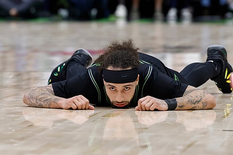 New Orleans Pelicans guard Jose Alvarado lies on the court after a foul against the Golden State Warriors during the third quarter of an NBA basketball game in New Orleans. 