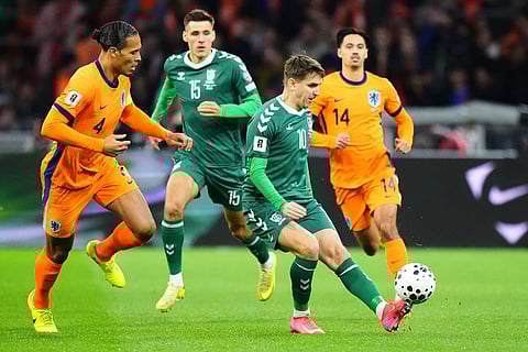 Lithuania's Fedor Cernych (10) kicks the ball past Netherlands' Virgil van Dijk during a World Cup 2026 group G qualifying soccer match between Netherlands and Lithuania in Amsterdam, Netherlands.