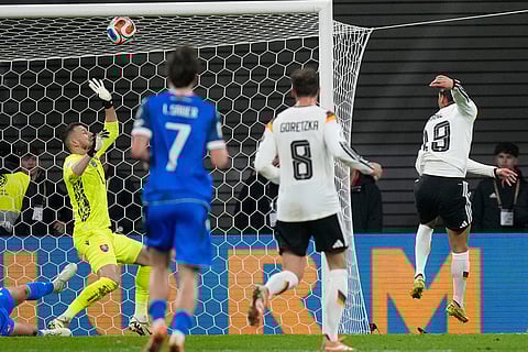 Germany's Leroy Sané scores during a group A World Cup qualifiying soccer match between Germany and Slovakia in Leipzig, Germany.