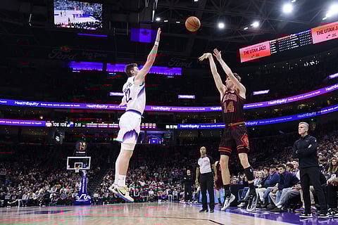 Chicago Bulls forward Matas Buzelis (14) takes a three-point shot over Utah Jazz forward Kyle Filipowski during the second half of an NBA basketball game in Salt Lake City. 