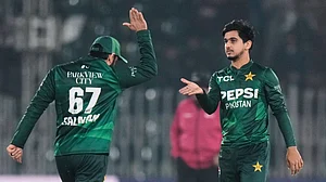(AP Photo/Anjum Naveed) : Pakistan's Saim Ayub, right, celebrates with teammate after taking the wicket of Zimbabwe's Brian Bennett during the tri-series T20 cricket match between Pakistan and Zimbabwe, in Rawalpindi, Pakistan, Tuesday, Nov. 18, 2025.