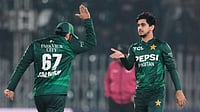 (AP Photo/Anjum Naveed) : Pakistan's Saim Ayub, right, celebrates with teammate after taking the wicket of Zimbabwe's Brian Bennett during the tri-series T20 cricket match between Pakistan and Zimbabwe, in Rawalpindi, Pakistan, Tuesday, Nov. 18, 2025. 