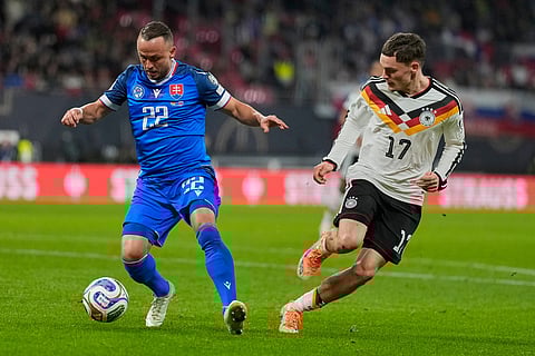 Slovakia's Tanislav Lobotka, left, and Germany's Florian Wirtz fight for the ball during a group A World Cup qualifiying soccer match between Germany and Slovakia in Leipzig, Germany.