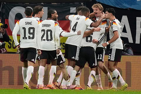 German players celebrate after scoring during a group A World Cup qualifiying soccer match between Germany and Slovakia in Leipzig, Germany.