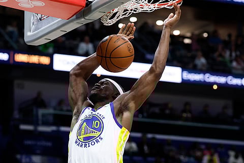 Golden State Warriors forward Jimmy Butler III slam dunks the ball during the second quarter of an NBA basketball game against the New Orleans Pelicans in New Orleans.